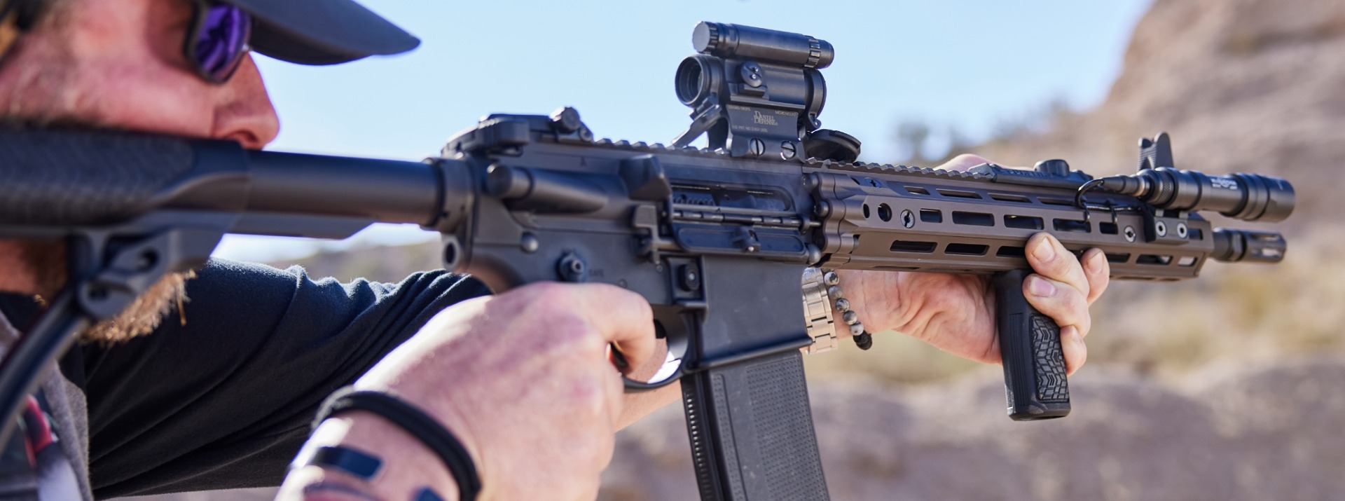 Man firing a Daniel Defense AR-15 style rifle